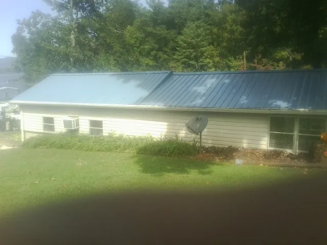 Blue metal roof running the length of a single story home in Ovid